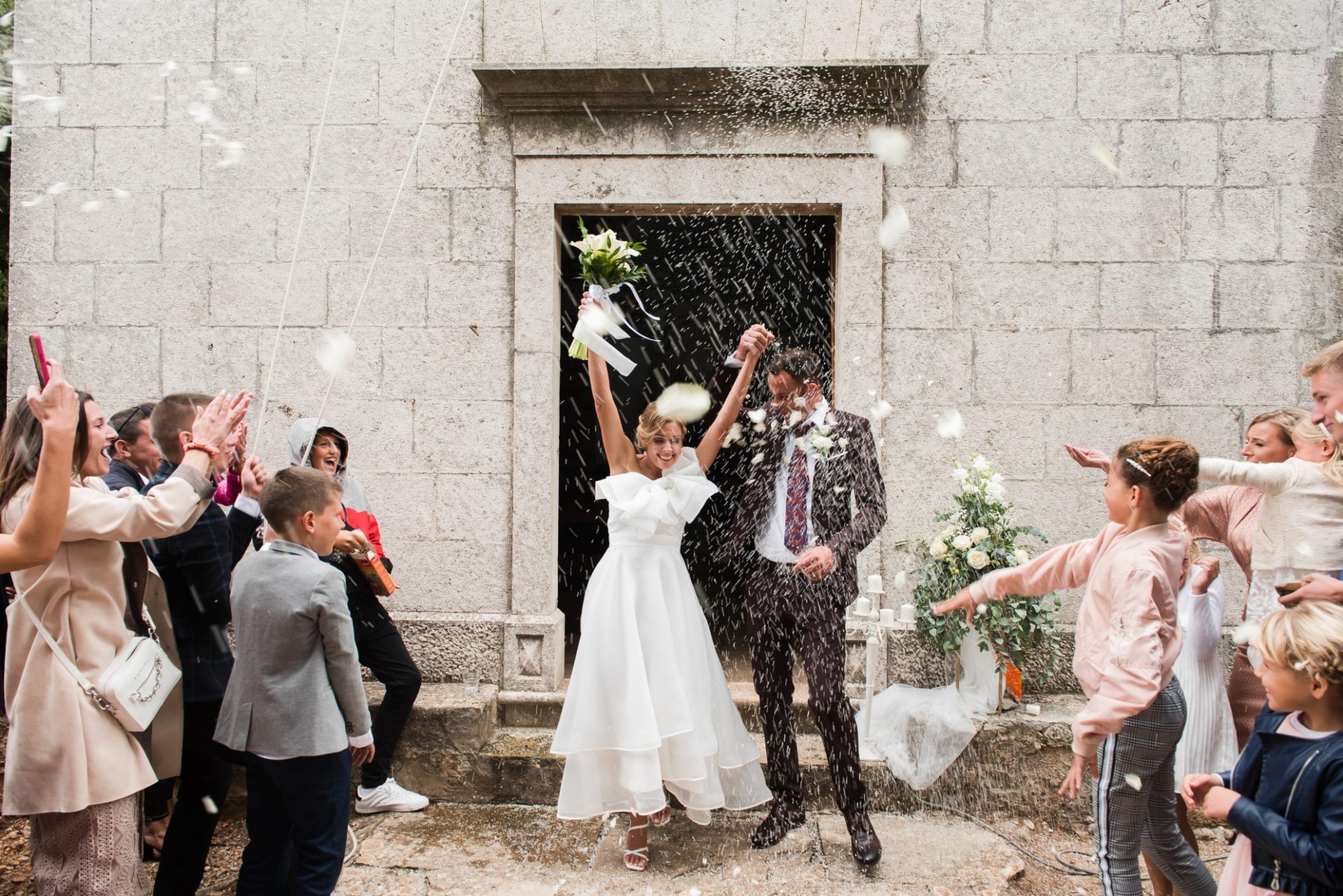 Kids throwing rice at the newlyweds